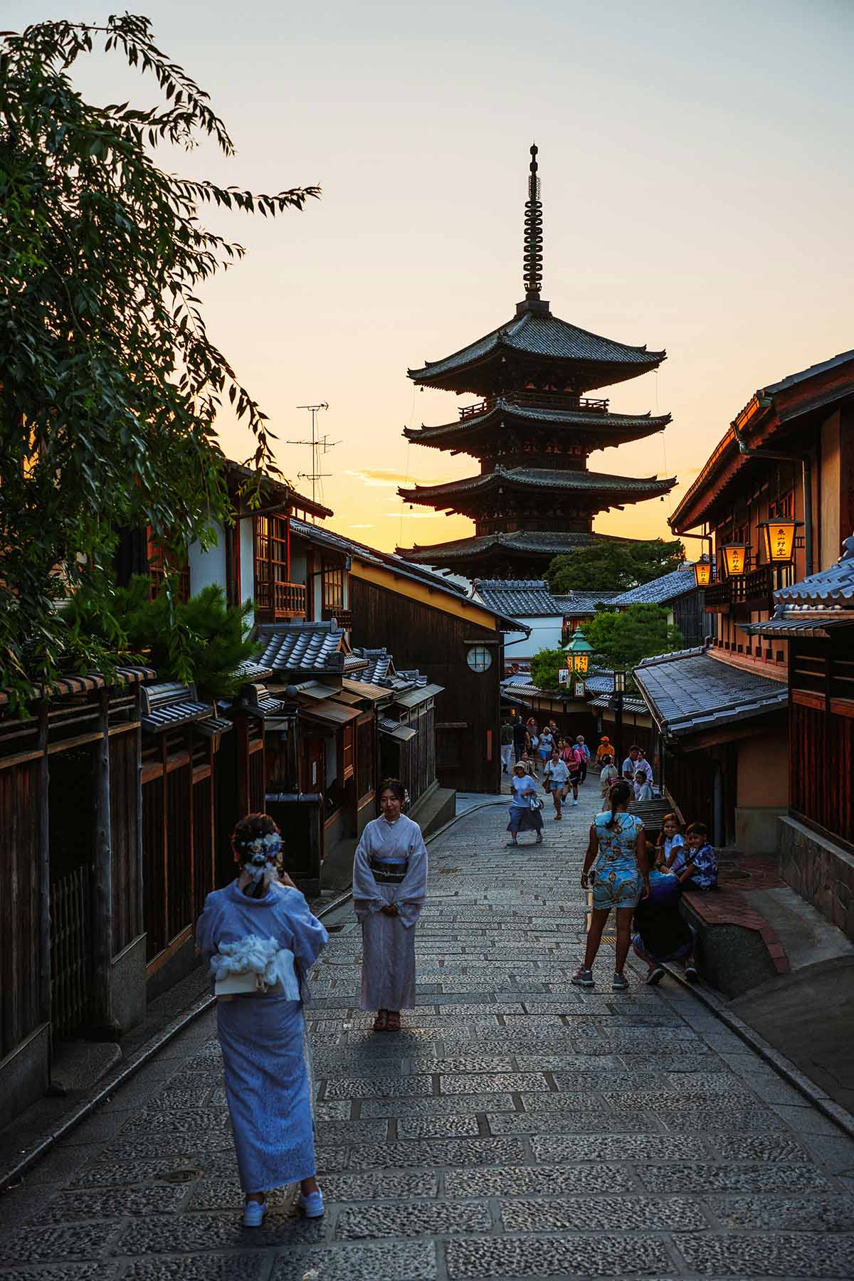 Traditional Japanese street in Higashiyama, Kyoto, with a pagoda visible at golden hour